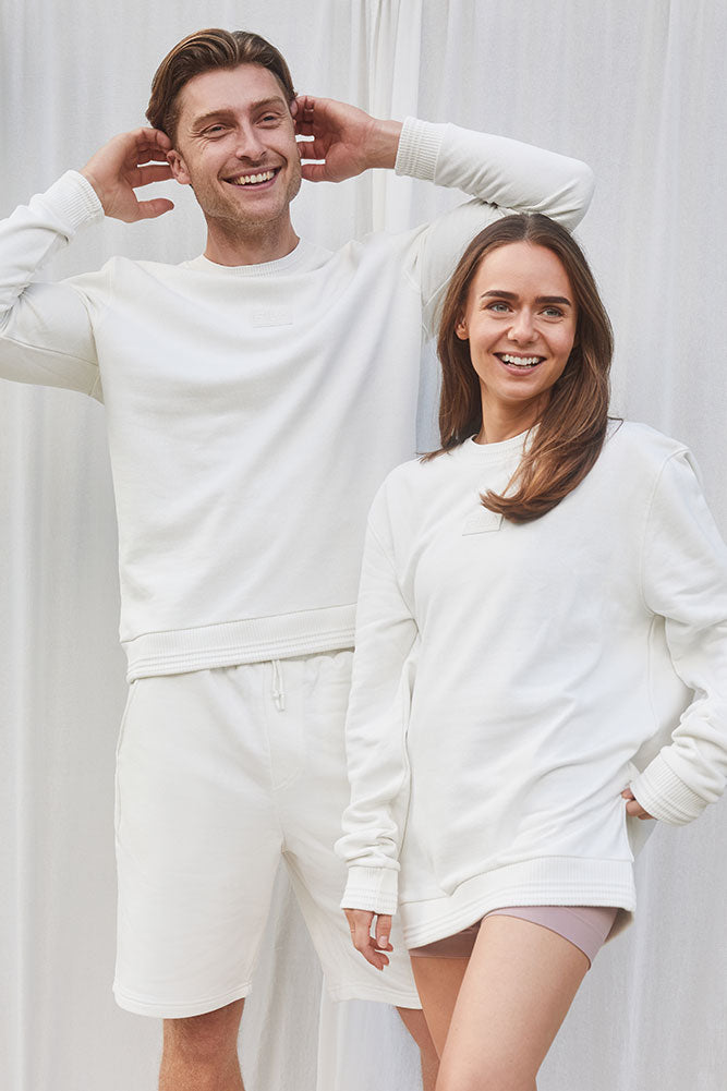 Unisex Fila Bruce sweatshirt in white made from recycled fabric shown on man and woman
