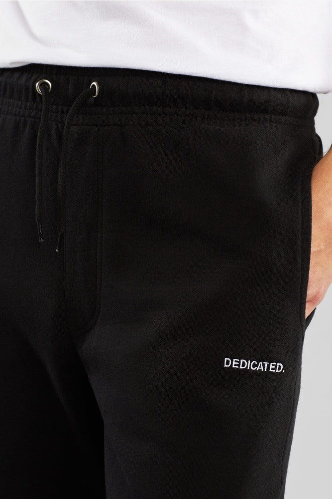 Black mens joggers by Dedicated with twin pockets and small Dedicated logo made from organic cotton