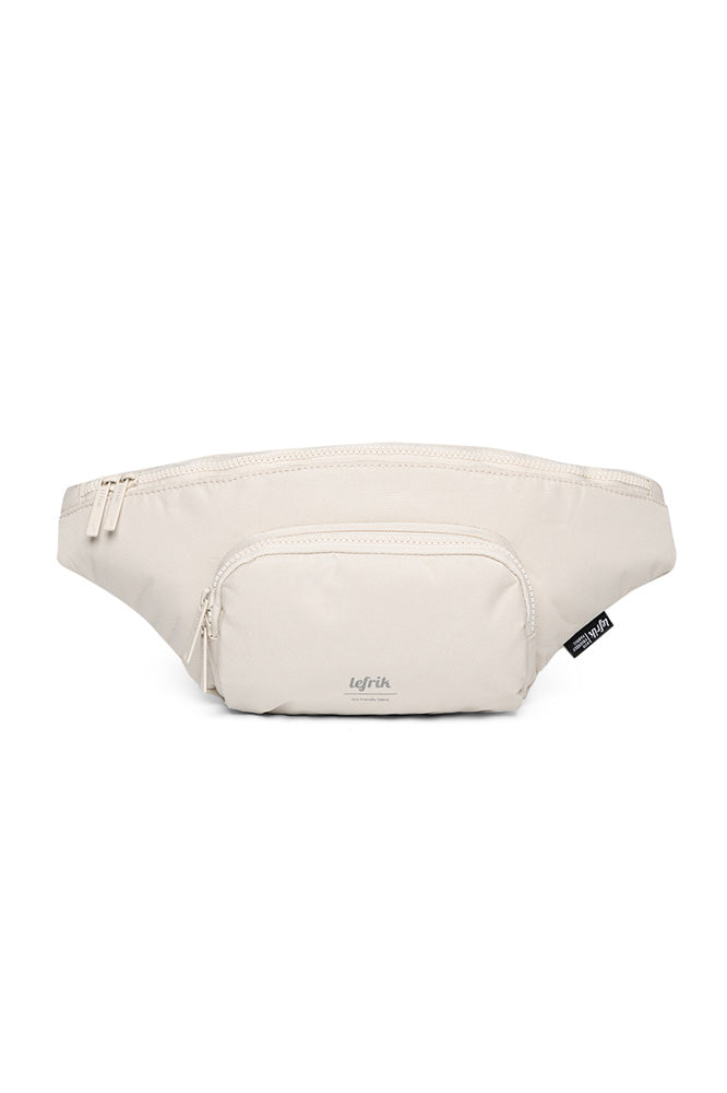Vegan neutral Lefrik recycled bottle atlas crossbody bag with double front pocket and tan strap